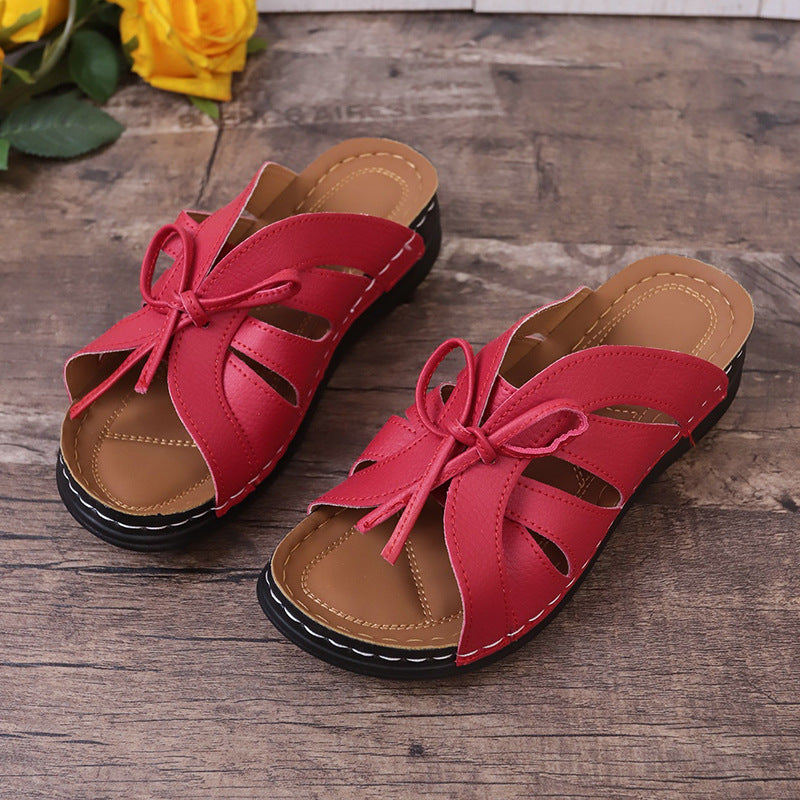 Sandalias de cuña plana con lazo calado