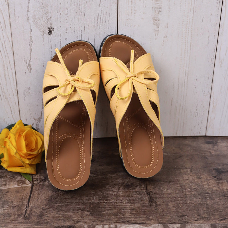 Sandalias de cuña plana con lazo calado